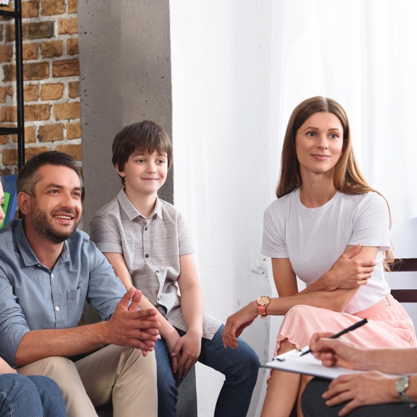 happy-family-sitting-on-therapy-session-by-female-2026-03-12-23-47-26-utc